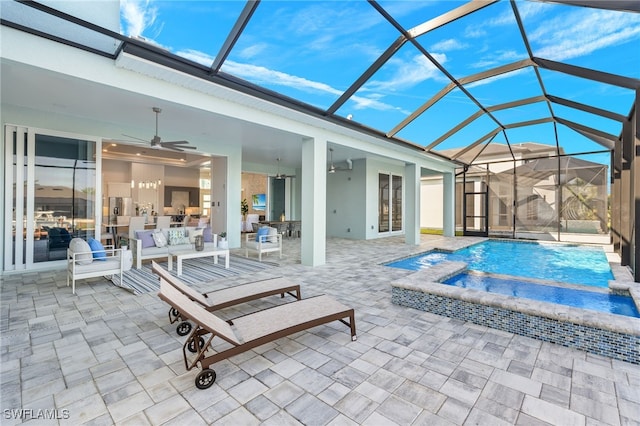 view of swimming pool featuring an in ground hot tub, glass enclosure, ceiling fan, and a patio area