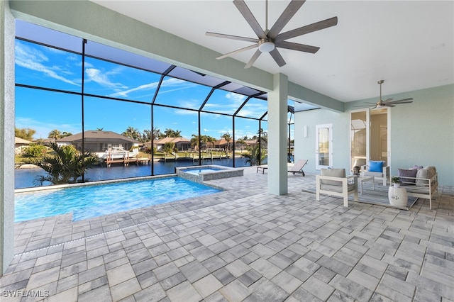 view of pool with an in ground hot tub, an outdoor hangout area, a lanai, a water view, and a patio