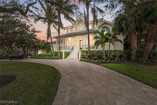 view of front of house with a lawn and covered porch