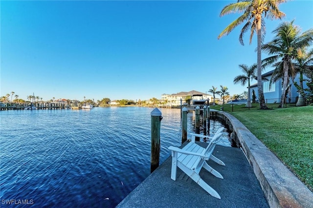 view of dock featuring a water view and a lawn