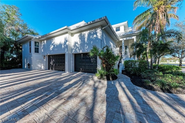 view of front of property featuring a porch and a garage