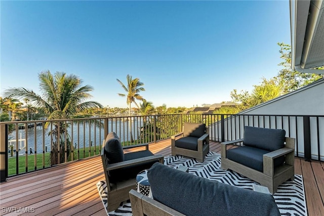 wooden terrace with outdoor lounge area and a water view