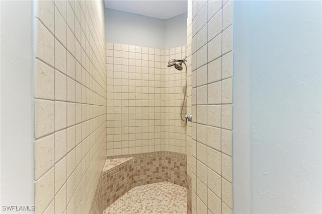 bathroom with a tile shower