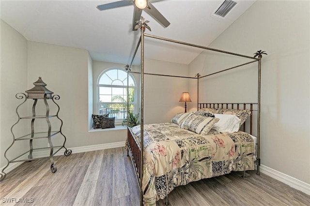 bedroom with ceiling fan, light wood-type flooring, and lofted ceiling