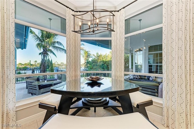 dining area with crown molding and a notable chandelier