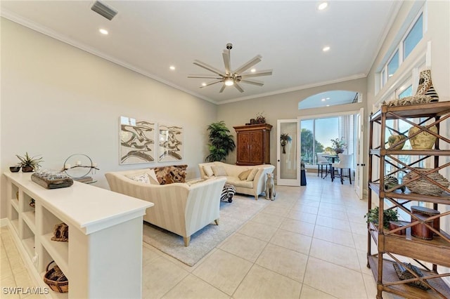 tiled living room with ceiling fan and crown molding