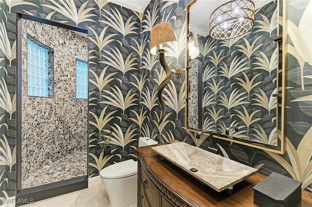 bathroom with tile patterned floors, vanity, toilet, and ornamental molding