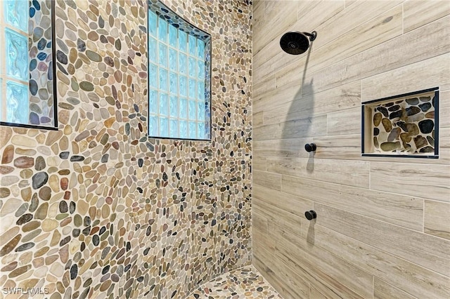 bathroom with a tile shower