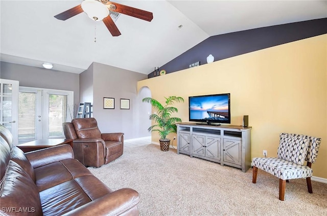 carpeted living room with ceiling fan and lofted ceiling