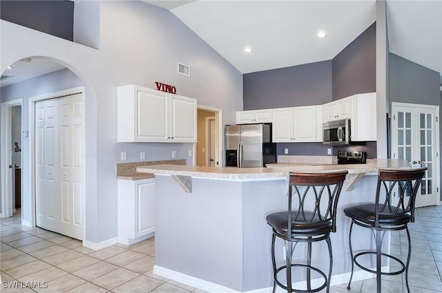 kitchen featuring white cabinetry, a kitchen island, and stainless steel appliances