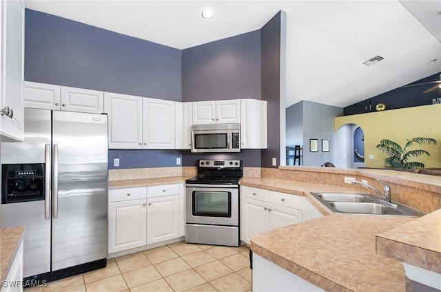 kitchen featuring kitchen peninsula, sink, light tile patterned floors, and stainless steel appliances