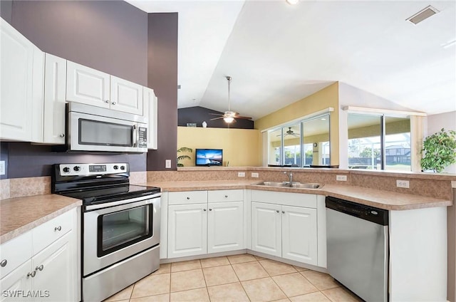 kitchen featuring white cabinets, appliances with stainless steel finishes, ceiling fan, and lofted ceiling