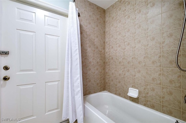 bathroom with shower / bath combination with curtain