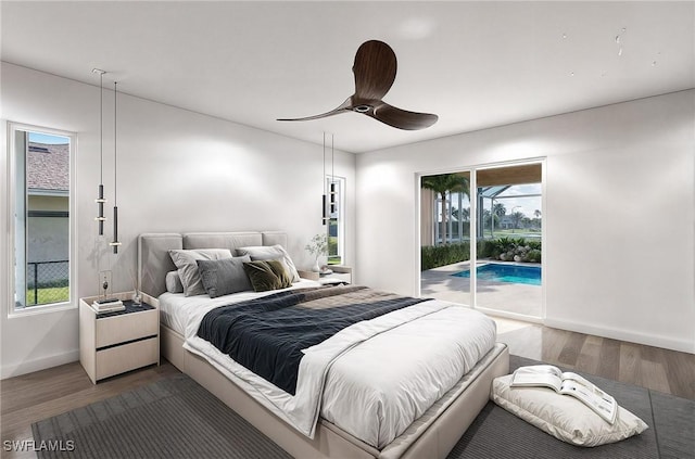 bedroom featuring access to exterior, ceiling fan, and dark hardwood / wood-style flooring