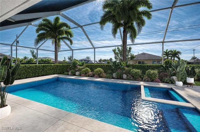 view of swimming pool featuring a lanai and a patio