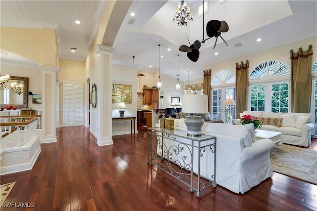 living room featuring decorative columns, high vaulted ceiling, dark hardwood / wood-style floors, and ornamental molding