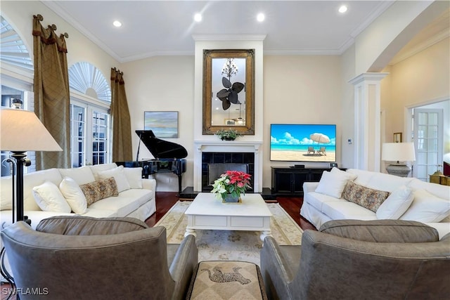 living room with decorative columns, a healthy amount of sunlight, crown molding, and wood-type flooring