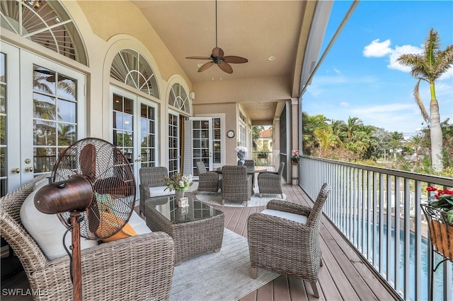 wooden deck featuring ceiling fan