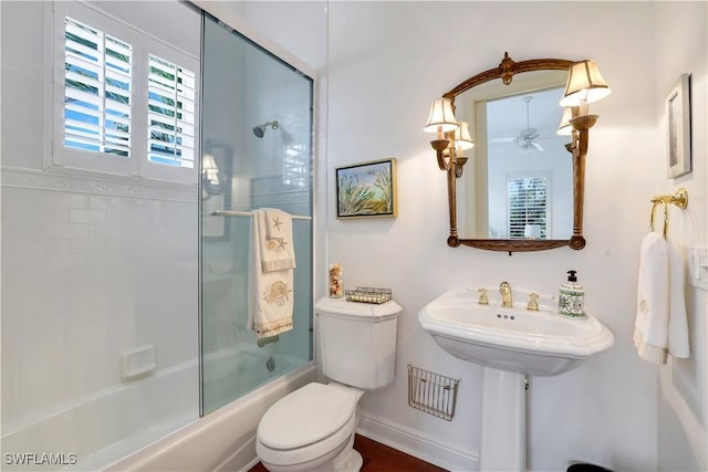 bathroom with shower / bath combination with glass door, ceiling fan, and toilet