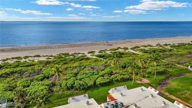 birds eye view of property with a water view and a beach view