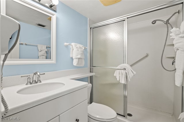 bathroom with vanity, toilet, and walk in shower