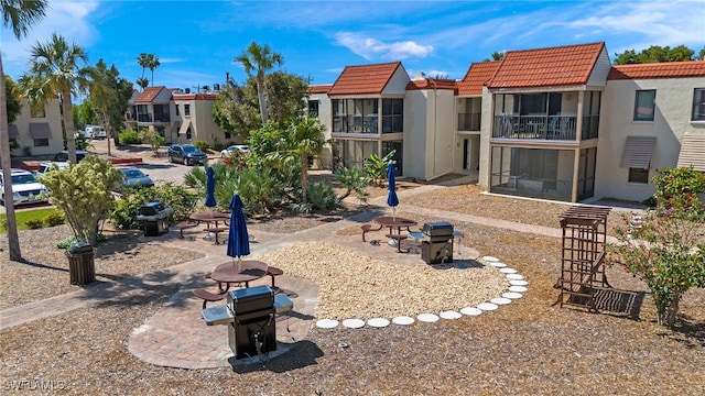 view of home's community with a patio and an outdoor fire pit