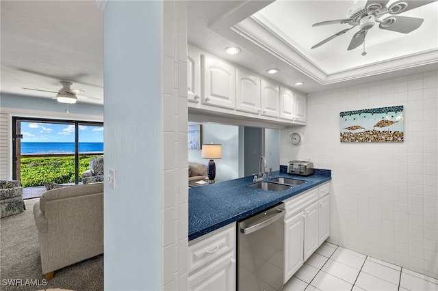 kitchen with white cabinetry, sink, ceiling fan, stainless steel dishwasher, and light tile patterned flooring