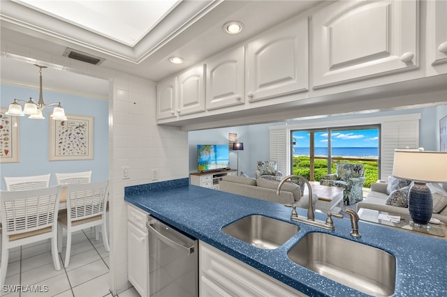 kitchen featuring white cabinets, crown molding, an inviting chandelier, dishwasher, and light tile patterned flooring