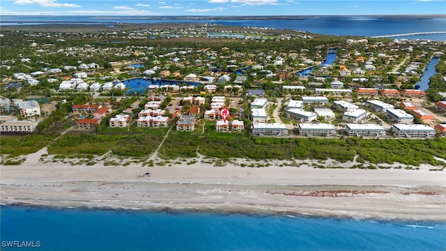 birds eye view of property featuring a water view and a beach view