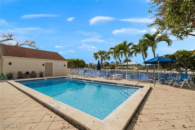 view of swimming pool featuring a water view