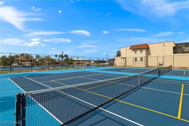 view of sport court featuring a water view and basketball court