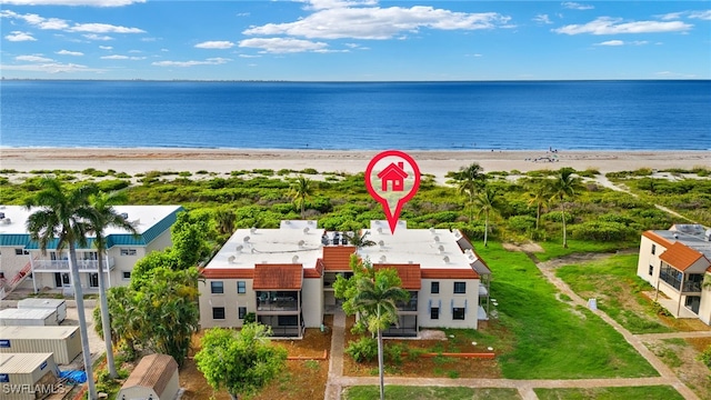 birds eye view of property featuring a water view and a beach view