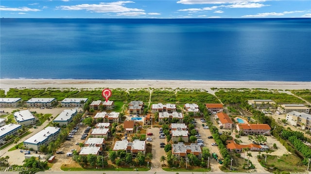 drone / aerial view with a water view and a beach view