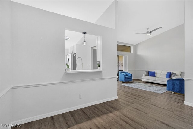 living room featuring wood-type flooring, ceiling fan, and lofted ceiling