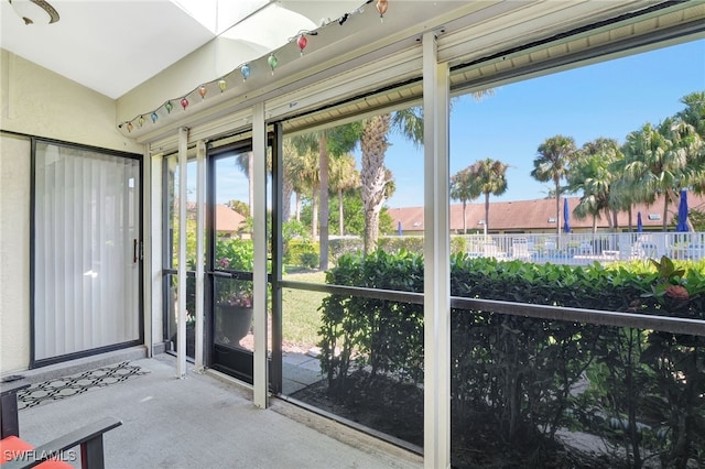 unfurnished sunroom with lofted ceiling