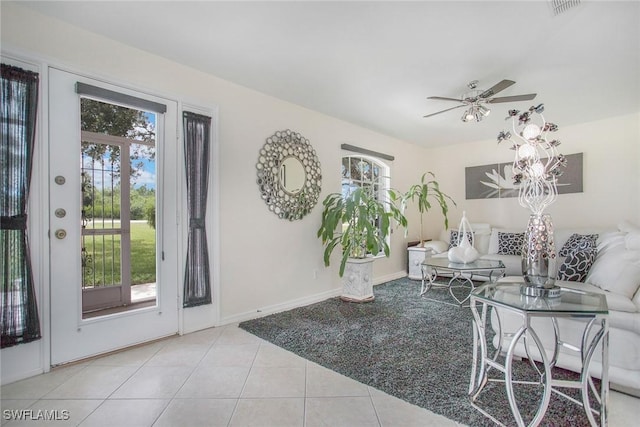 tiled living room featuring ceiling fan