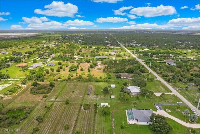 birds eye view of property with a rural view