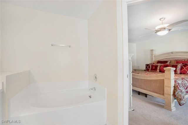 bathroom with ceiling fan and a bathtub