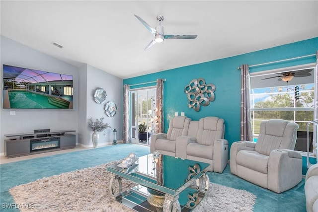 carpeted living room featuring a wealth of natural light, ceiling fan, and vaulted ceiling