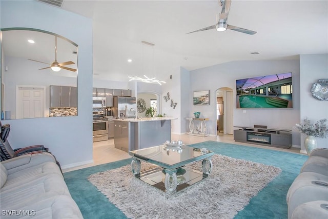 living room with lofted ceiling and sink