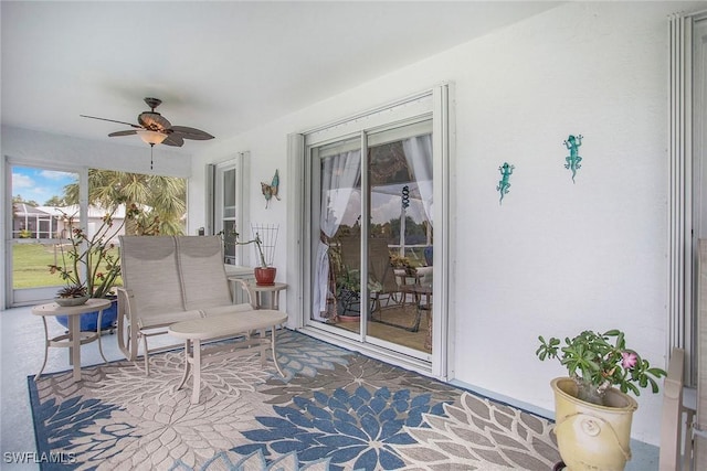 sunroom / solarium featuring ceiling fan