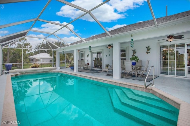 view of pool with a lanai, ceiling fan, and a patio area