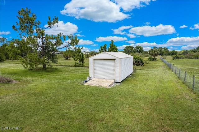 view of outbuilding featuring a rural view and a yard