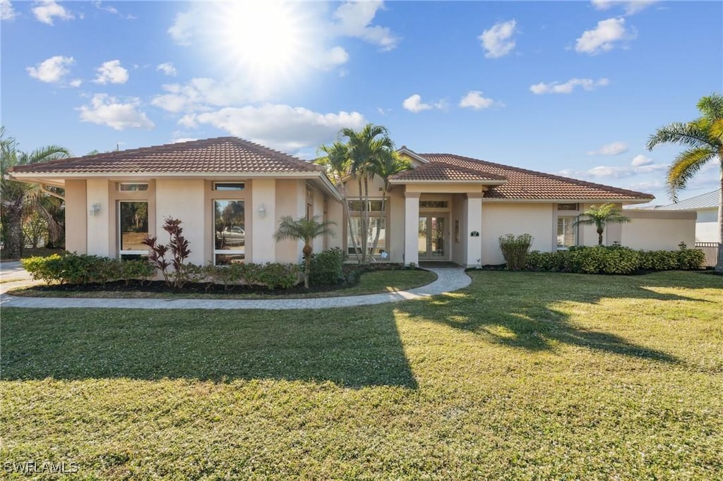 mediterranean / spanish home featuring a front yard