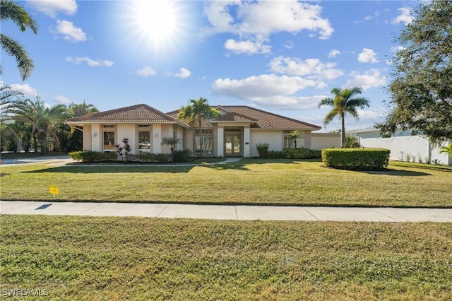 mediterranean / spanish-style house featuring a front lawn