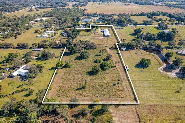 birds eye view of property with a rural view