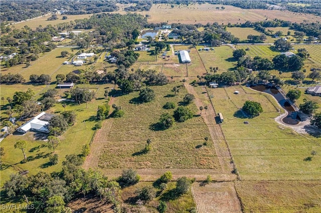 birds eye view of property featuring a rural view and a water view