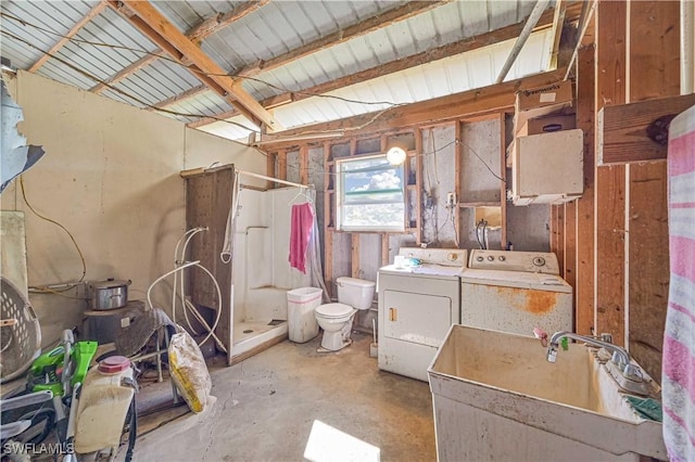 bathroom with a shower, sink, toilet, separate washer and dryer, and concrete floors