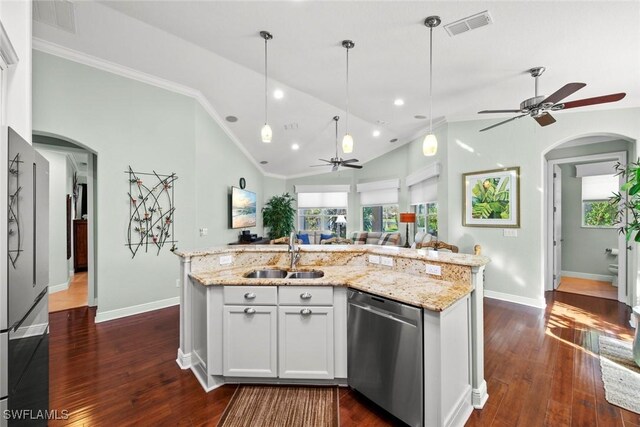 kitchen featuring sink, an island with sink, vaulted ceiling, white cabinets, and appliances with stainless steel finishes