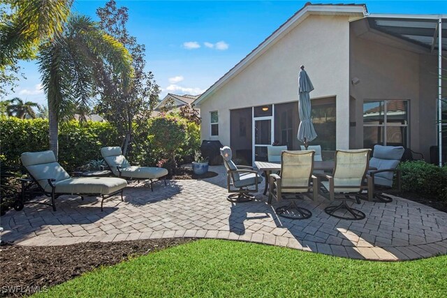 view of patio with a sunroom